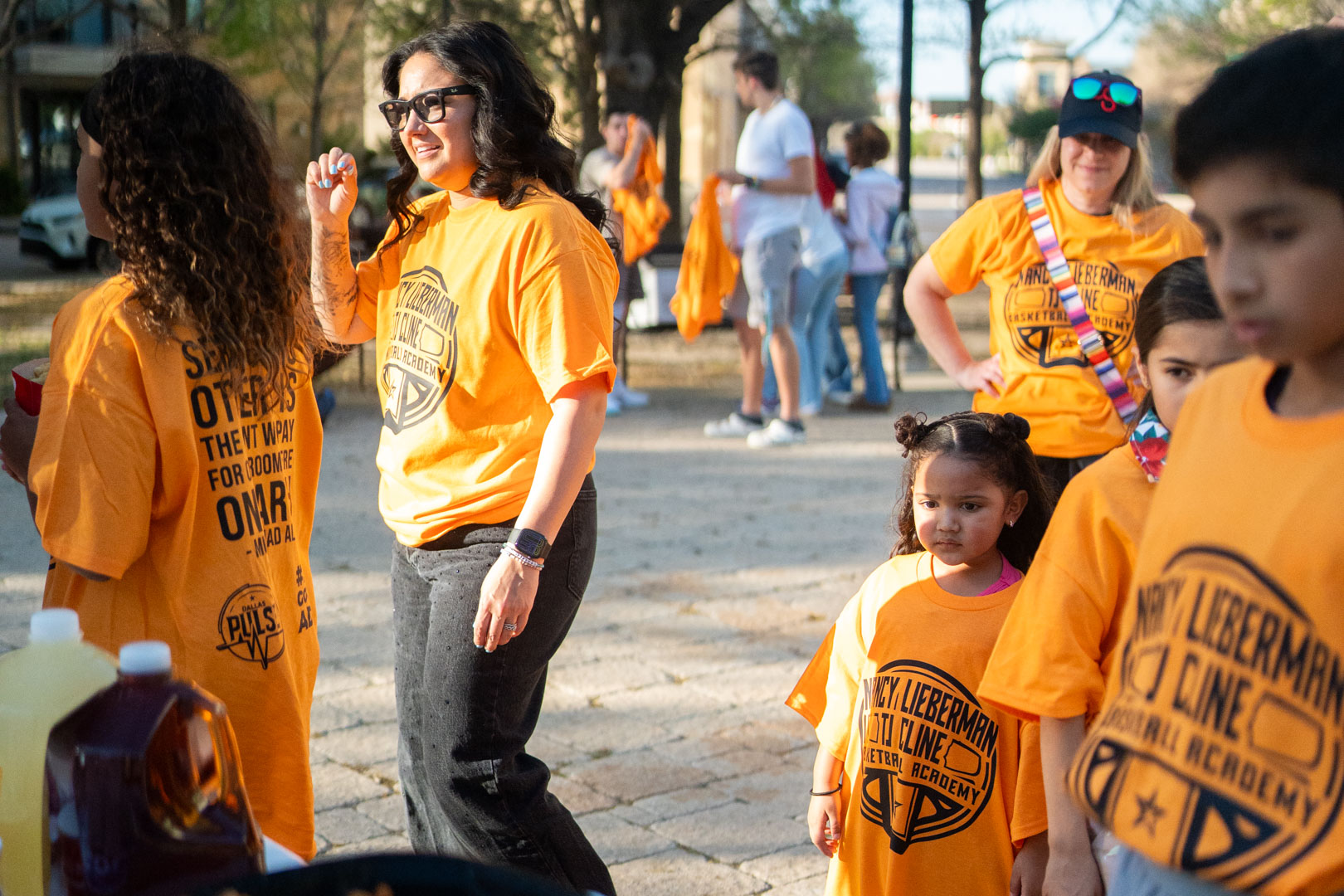 The group gathering outside in matching orange shirts before heading into the arena